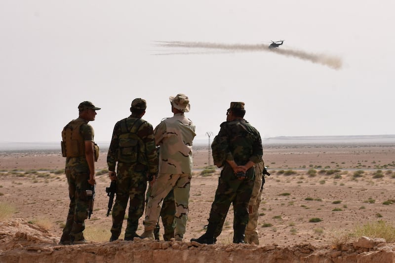 TOPSHOT - A helicopter fires rockets as Syrian government forces hold a position in Kobajjep area, on the southwestern outskirts of Deir Ezzor, on September 5, 2017, during the ongoing battle against Islamic State (IS) group jihadists.
Syria's army and allied fighters, backed by Russian air support, have been advancing towards Deir Ezzor on several fronts in recent weeks, and entered the Brigade 137 base on its western edge, in what Moscow hailed as a key "strategic victory". / AFP PHOTO / George OURFALIAN