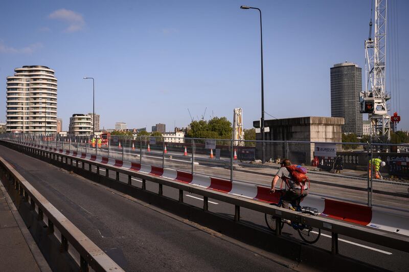 LONDON, ENGLAND - SEPTEMBER 17: A cyclist rides over Vauxhall Bridge on September 17, 2020 in London, England. A number of London's bridges have recently either needed emergency repairs, or have been closed to the public entirely due to fears that they are structurally unsafe. In late August, Tower Bridge was closed for 48 hours after it suffered "technical issues" resulting in the iconic bridge remaining in the upright position, and Hammersmith Bridge has been closed to the public since April 2019 as it undergoes major structural repair. Elsewhere along the river, Vauxhall Bridge and London Bridge are closed to car traffic as urgent repair work takes place. Campaign groups have called for the repairs to be carried out in full and at speed, as roads and commutes become harder as people return to work after the COVID-19 lockdown. (Photo by Leon Neal/Getty Images)