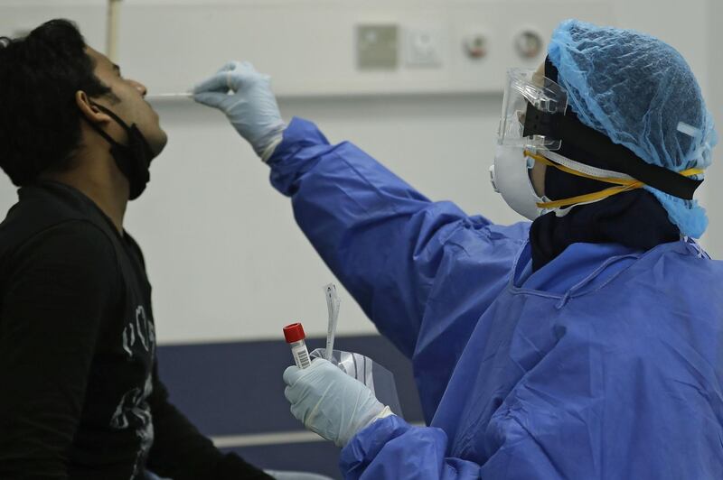 A nurse takes a mucus sample from a suspected coronavirus patient at the Rafik Hariri public hospital in the Lebanese capital Beirut.  AFP