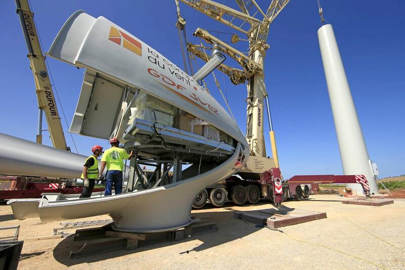 Employees work on the nacelle of an E-70 wind turbine during its installation at a wind farm in Meneslies, France. Benoit Tessier / Reuters