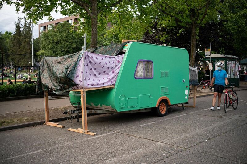 A person walks by a camping trailer in the so-called "Capitol Hill Autonomous Zone." Getty Images/AFP