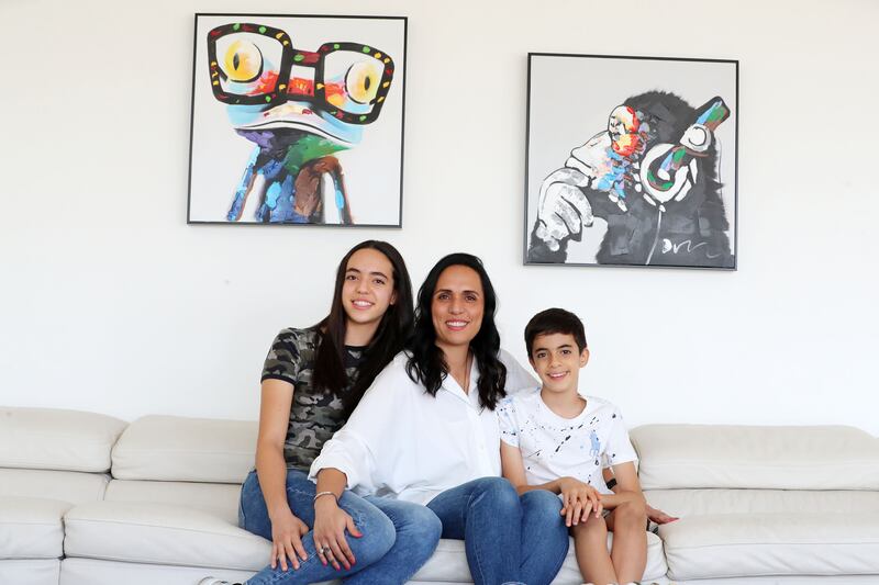 Adam Al Rafey at home with his mother, Suha El Halfawi, and sister, Laila Al Rafey, in Arabian Ranches, Dubai. Reem Mohammed / The National
