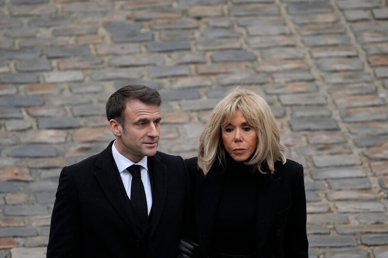 President Macron and his wife Brigitte leaving after the ceremony. AP