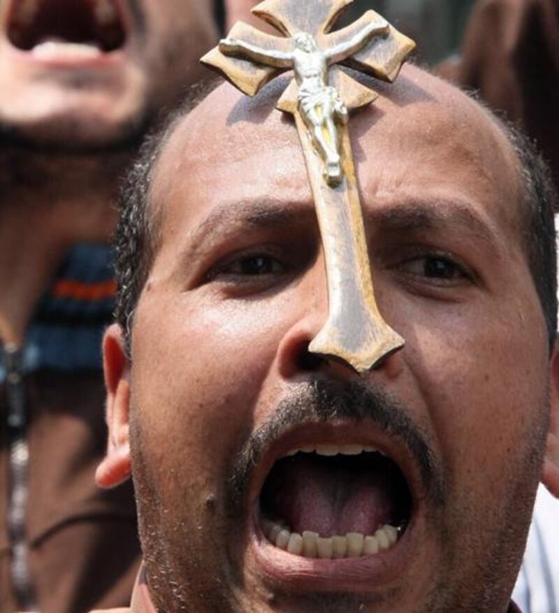 Egyptian Christians protest in front of the state television building in Cairo on May 15, 2011 as the head of Egypt's Coptic church called on Christians to "immediately" end their week-long sit-in, a day after fresh clashes left 78 injured further fuelling fears of widespread sectarian unrest. The clashes broke out after an altercation between a young Muslim and Coptic Christians who have been staging a sit-in -- to demand equality and an end to discrimination -- outside the state television building in Cairo since May 7, after sectarian unrest last week that left 15 dead, police said.   AFP PHOTO / KHALED DESOUKI

