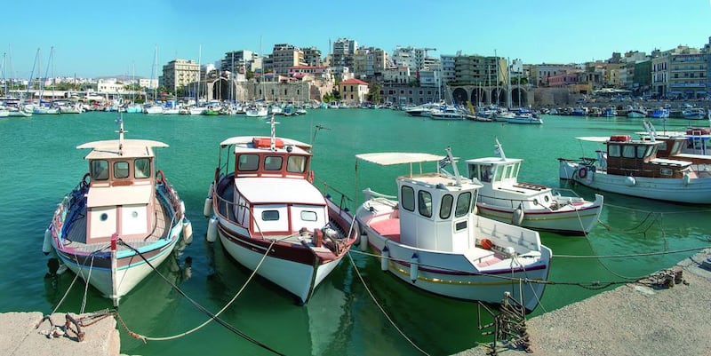 Traditional fishing boats in the port of the modern city of Heraklion (Iraklio), Crete, Greece. Getty Images