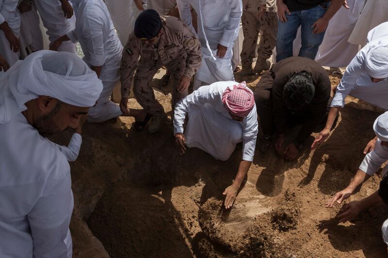 FUJEIRAH, UNITED ARAB EMIRATES, 19 JUNE 2017. The funeral of Emirati Athlete Abdullah Hayayei in Qidfa that died from an accident in London while training. Family and commmunity members lay Abdullah's body to rest at the cemetery in Qidfa. (Photo: Antonie Robertson/The National) Journalist: Ruba Haza. Section: National.