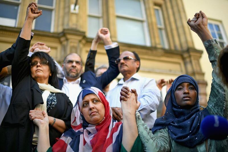 Manchester resident Gulnar Bano Kham Ghadri wears a Union Jack head scarf during a multi-faith vigil at the city's St Ann's Square on May 24, 2017. Jeff J Mitchell / Getty Images