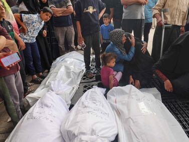 EDITORS NOTE: Graphic content / Palestinians mourn by the bodies of relatives killed in Israeli bombardment, at the al-Najjar hospital in Rafah in the southern Gaza Strip, on April 25, 2024 amid the ongoing conflict between Israel and the Palestinian militant group Hamas.  (Photo by MOHAMMED ABED  /  AFP)