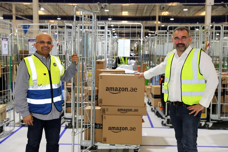 Prashant Saran, director of operations at Amazon Turkey, Middle East and Africa, and Stefano Martinelli, vice president of Amazon in the UAE and Saudi Arabia, at the company's delivery station in Dubai. Pawan Singh / The National