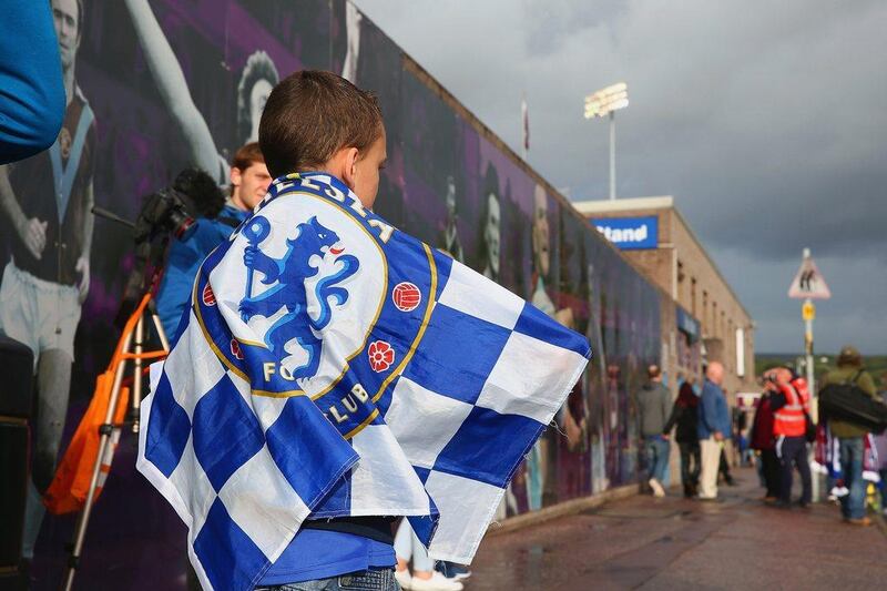 A Chelsea fan wears the club flag before their match against Burnley on Monday night at Turf Moor. Clive Brunskill / Getty Images 
