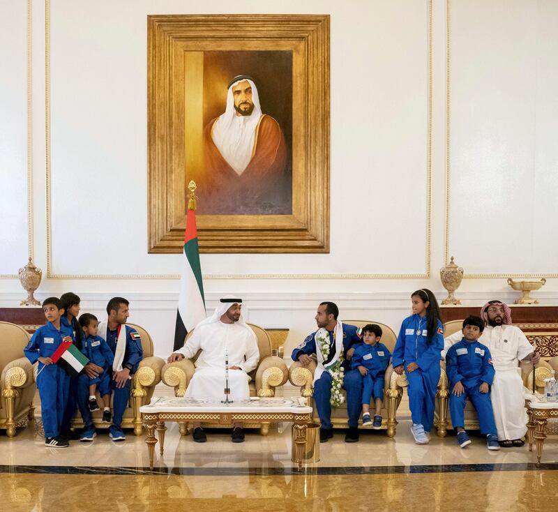 ABU DHABI, UNITED ARAB EMIRATES - October 12, 2019: HH Sheikh Mohamed bin Zayed Al Nahyan, Crown Prince of Abu Dhabi and Deputy Supreme Commander of the UAE Armed Forces (6th R), receives Hazza Ali Al Mansoori, the first UAE Astronaut to be deployed on a space mission to the International Space Station (ISS) (5th R), and Sultan Saif Al Neyadi, a member of the International Space Station mission back-up team (7th R), during a home-coming reception at the Presidential Airport. 

( Hamad Al Kaabi / Ministry of Presidential Affairs )​
---