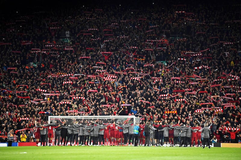 Liverpool players celebrate in front of the home fans after the match. Getty