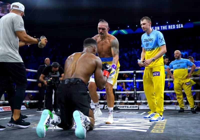 Anthony Joshua and Oleksandr Usyk touch gloves at the end of the fight. PA