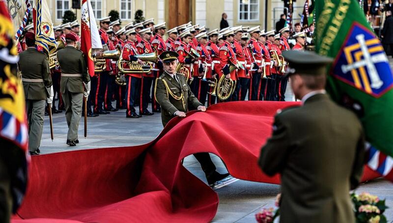 A member of the Honour Guard tries to rearrange the red carpet as strong winds disturb the welcoming ceremony for Chinese President Xi Jinping (at Prague Castle in the Czech Republic. Filip Singer / EPA