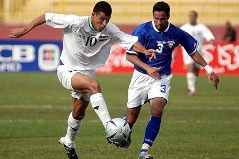 Iraq's Yunis Khalaf, left, fights for the ball against Kuwait's Saqer Al Antari during a friendly match in Amman. The two rivals renew their battles on the pitch in the Gulf Cup of Nations starting Saturday.