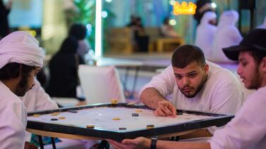 Carrom games are a common sight in Ramadan; they're usually played after taraweeh prayers. Photo: Manarat Al Saadiyat