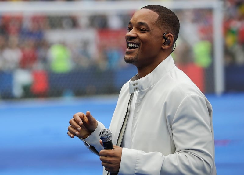FILE - In this July 15, 2018, file photo, singer and actor Will Smith performs during the closing ceremony prior to the final match between France and Croatia at the 2018 soccer World Cup in the Luzhniki Stadium in Moscow, Russia. The star on Wednesday, Oct. 10, revealed the first poster of Disney's remake of "Aladdin."  Smith, who plays the Genie, wrote on Facebook: "LEMME OUT! Can't wait for y'all to see Me BLUE." (AP Photo/Matthias Schrader, File)