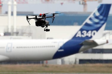 A drone flies near an Airbus A340 aircraft in Colomiers near Toulouse, France, October 19, 2017. Reuters