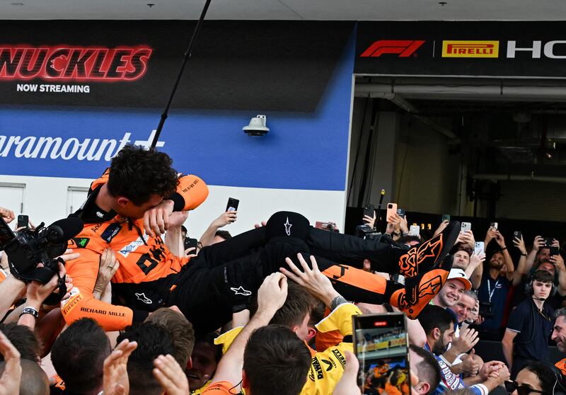 Lando Norris is tossed in the air by McLaren teammates after his breakthrough victory in Miami. AFP