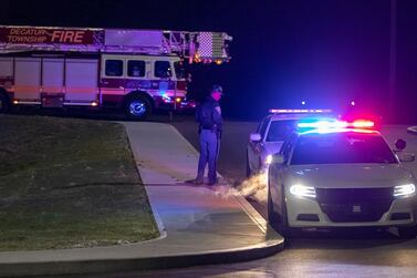 Police and fire teams arrive at the scene outside a FedEx facility in Indianapolis. The Indianapolis Star via AP