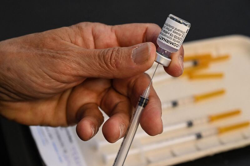 A nurse prepares a dose of the Pfizer/BioNTech vaccine against Covid-19 with a syringe during a vaccination campaign at the city hall of Montpellier, southern France on April 15, 2021, aimed at stemming the spread of the Covid-19 pandemic.  / AFP / Pascal GUYOT
