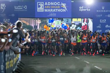 Runners begin the inaugural Adnoc Abu Dhabi Marathon on Friday morning. Leslie Pableo for The National