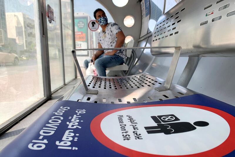 DUBAI, UNITED ARAB EMIRATES , October 3 – 2020 :- Social distancing stickers pasted at the Bus stop as a preventive measure against the spread of coronavirus in Al Karama area in Dubai. (Pawan Singh / The National) For News/Stock/Online.