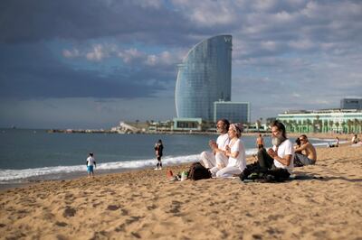 epa08482068 Several people meditate on Barceloneta beach, in Barcelona, in Barcelona, Spain, 13 June 2020. Barcelona is in phase 2 of coronavirus lockdown exit process.  EPA/Marta Perez