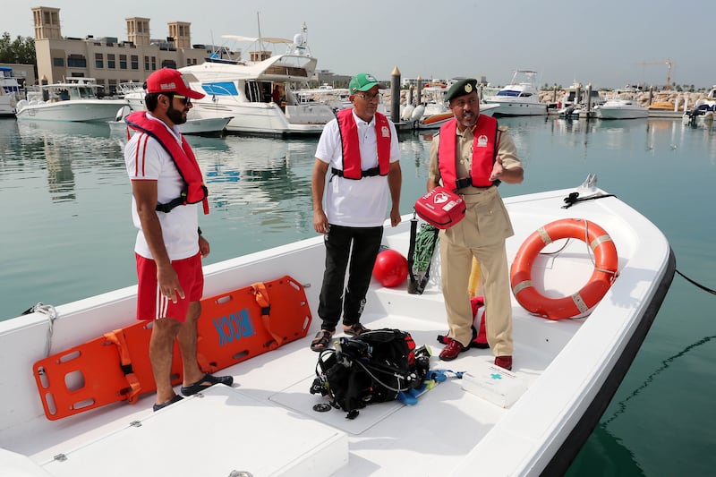 DUBAI , UNITED ARAB EMIRATES , November 26  – 2018 :- Lt. Colonel Ali Abdullah Al Qaseeb Al Naqbi , Head of the Maritime Rescue ( right ) explaining about the rescue equipment at the Fishermen village in Jumeirah in Dubai. ( Pawan Singh / The National ) For News. Story by Salam