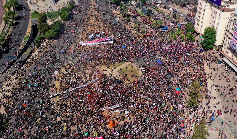 An aerial view of a demonstration with a banner reading “We will overcome” commemorating the anniversary of the social uprising in Chile, in Santiago.  AFP