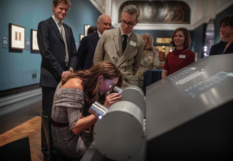 Looking through a stereograph as she officially opens the new photography centre at the Victoria and Albert (V&A) Museum in London in October. AFP