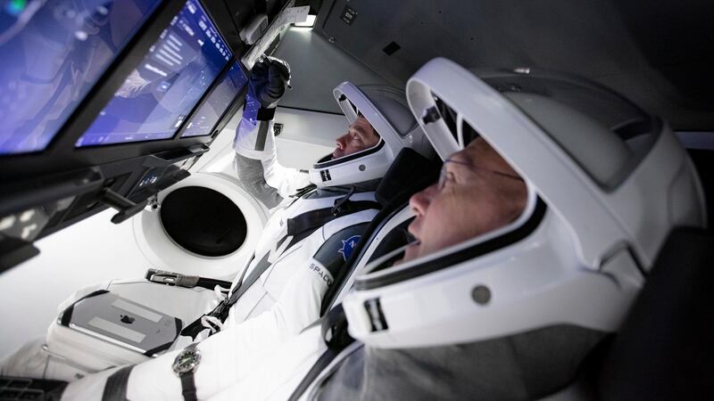 Astronauts Doug Hurley, foreground, and Bob Behnken in SpaceX's flight simulator. AP