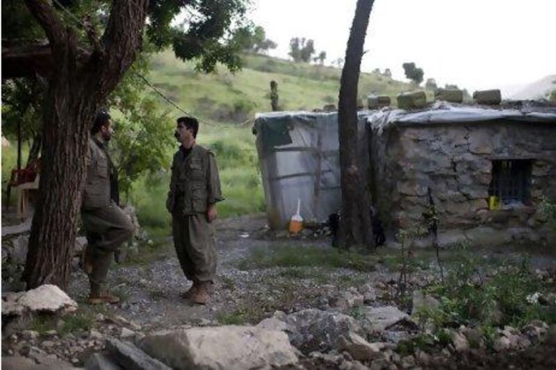 Shamal Bishir (left) and Shirzad Kamangar, members of the guerrilla group PJAK (Party of Free Life in Kurdistan), at the group's base in Iraq, from which it launches what it calls 'defensive' military campaigns in Iran.