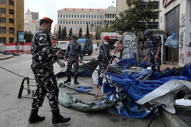 Lebanese security forces pull down tents as they clear away a protest camp and reopened roads blocked by demonstrators since protests against the governing elite started in October 2019. Reuters