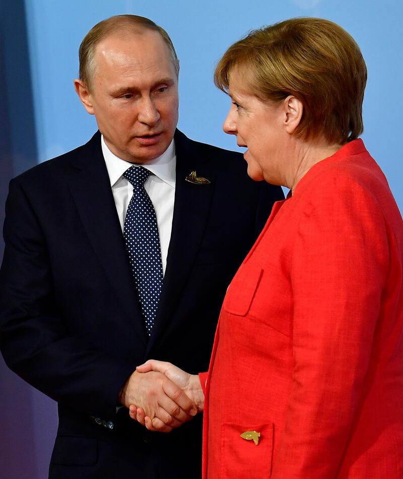 Mrs Merkel pictured with Mr Putin.