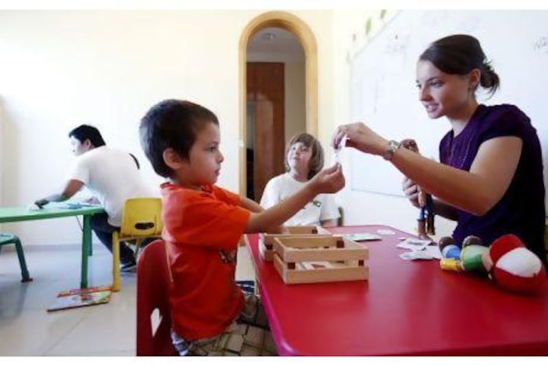Bennett Freitag, 5, and Pedro Markus, 6, enjoy an activity session with head teacher, Amanda Smith, last month at the Child Learning and Enrichment Medical Centre in Dubai last. Sarah Dea / The National