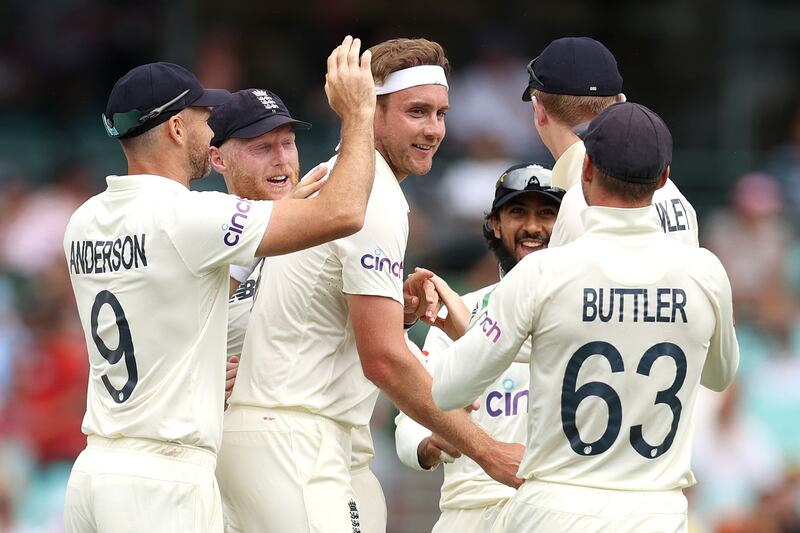 James Anderson, Stuart Broad and Jos Buttler of England celebrate the wicket of David Warner. Getty Images