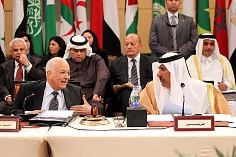 The Arab League secretary general, Nabil Alarabi, and the Qatari foreign minister, Hamad bin Jasim, attend the Arab Foreign Ministers committee emergency meeting about Syria in Cairo yesterday.