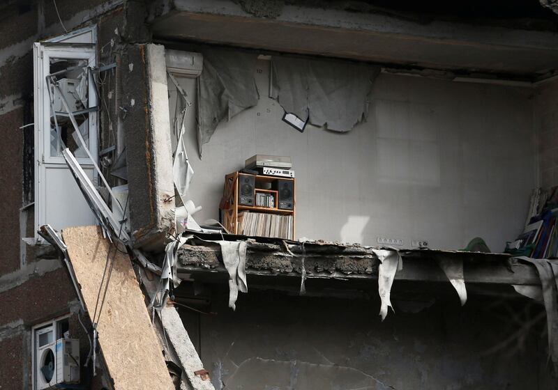 A record player sits among debris inside an apartment in Mariupol. Reuters