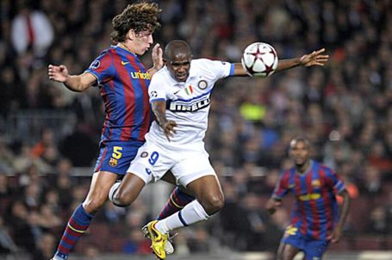 Inter's Samuel Eto'o, right, heads the ball in Champions League action against Barcelona.