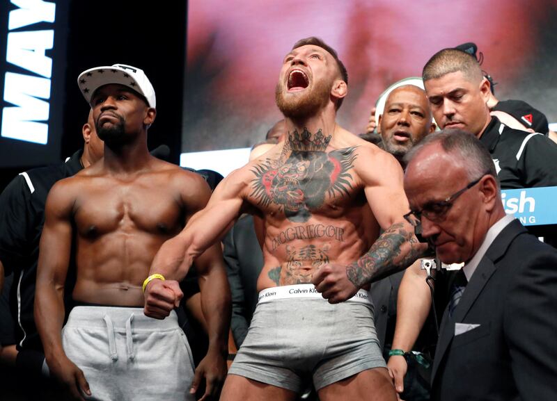 Undefeated boxer Floyd Mayweather Jr. (L) of the U.S. and UFC lightweight champion Conor McGregor of Ireland pose during their official weigh-in at T-Mobile Arena in Las Vegas, Nevada, U.S. on August 25, 2017. REUTERS/Steve Marcus