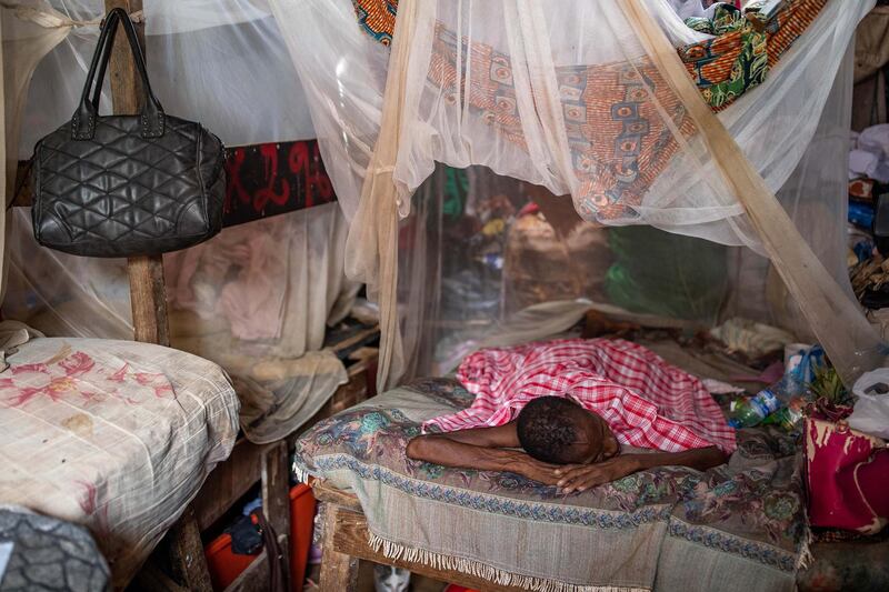 FOR MALARIA / SMALPOX GALLERY LUANDA, ANGOLA - JANUARY 27: A woman, suffering from malaria, rests on her families bed inside the Povoado slum on January 27, 2020 in Luanda, Angola. Eight families live in this room, each with one bed. In June 2013, 3000 families were evicted from a shanty town called Areia Branca, forcibly removed without warning by police and local officials.  500 families have relocated to a former waste dump known as Povoado, where two sewage channels flow through their encampment and diseases such as meningitis, tuberculosis and malaria are common. Residents  have raised their beds high off the ground as during storms and particularly high tides their houses flood with sewage from the nearby lagoon. The Luanda Leaks investigation suggests that Isabel dos Santos’s company,  Urbinveste, would benefit from the redevelopment of Areia Branca, claims she denies. Dos Santos said her plans, which were backed by her father, did not require evictions. She also insists her business relationship with her father’s government was “arm’s length”, and that she was “not financed by any state money or funds”. Businesswoman Isabel dos Santos is the daughter of the former President of Angola - Jose Eduardo dos Santos. Forbes Magazine put her fortune at $2.1billion making her the richest woman in Africa. How she made her fortune has come under scrutiny as international media using information from the Luanda Leaks have revealed how, during his presidency, her father sanctioned her acquisition of stakes in Angolan industries including banking, diamonds, oil and telecoms. In December 2019 the Angolan Courts froze Dos Santos's stakes in Angolan companies as it bought a case against her regarding funds owed to the state oil firm. (Photo by Luke Dray/Getty Images)