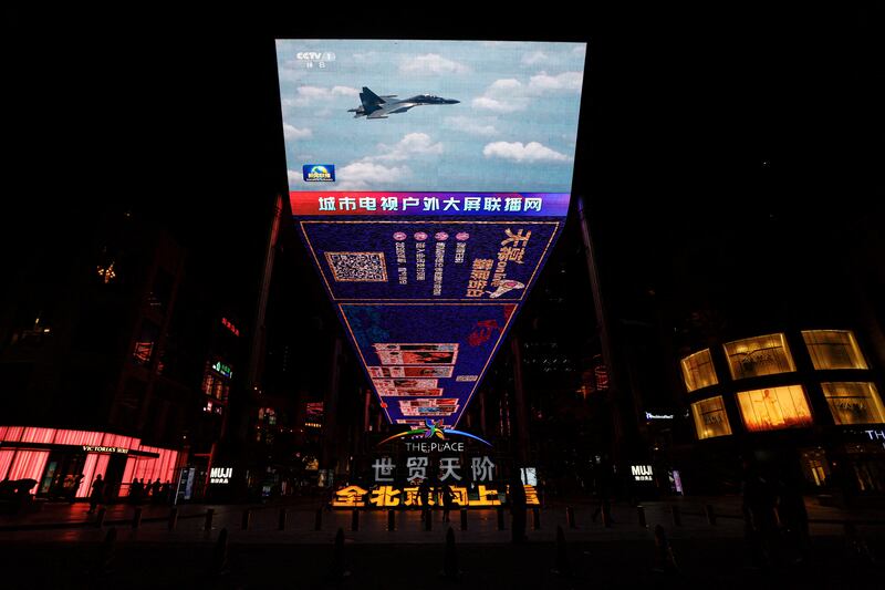 A giant screen in Beijing broadcasts footage on April 8 of an Air Force fighter jet attending combat exercises around Taiwan. Reuters