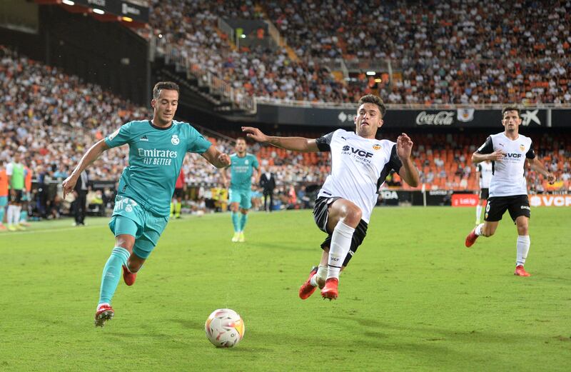 Real Madrid forward Lucas Vazquez of Real Madrid gets set to put in a cross as Valencia's Hugo Duro attempts to lunge in with a block. Getty Images