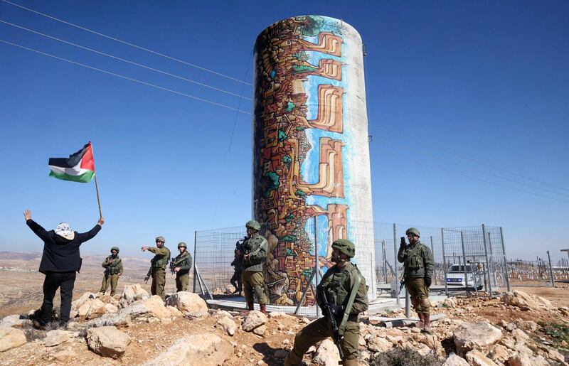 Israeli security officers deploy as Palestinian landowners demonstrate next to land confiscated for the Israeli settlement of Karmel (background), near Yatta village south of Hebron city in the occupied West Bank. AFP