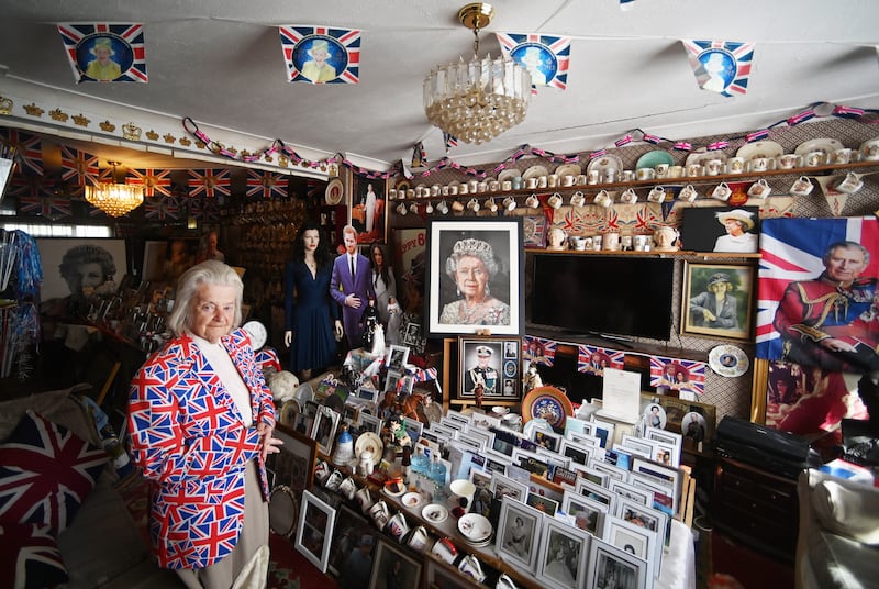 Royal fan Margaret Tyler poses for a portrait in the living room of her home in north London. EPA