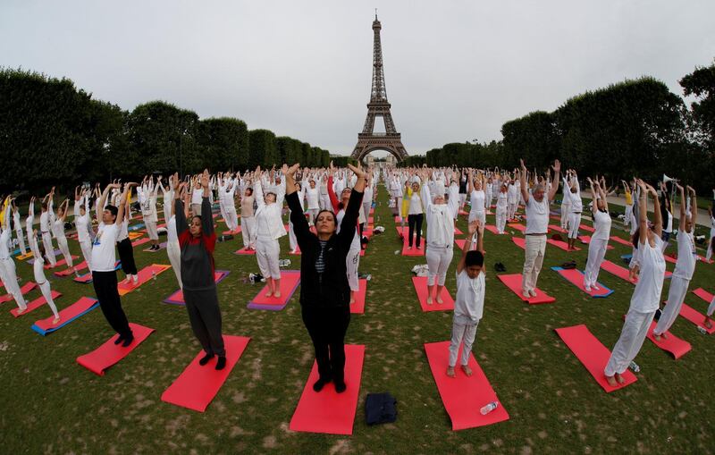 People gather for an open-air yoga session near the Eiffel Tower in Paris, France. Philippe Wojazer / Reuters