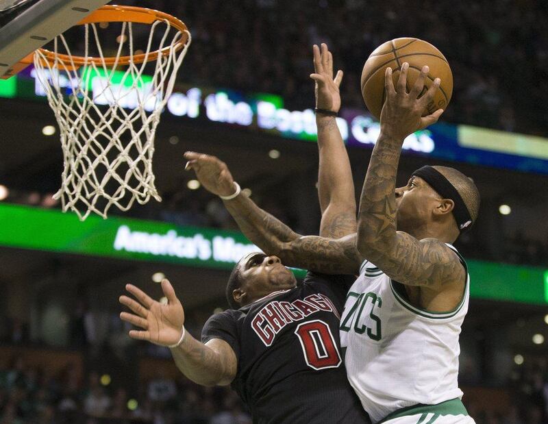 Boston Celtics guard Isaiah Thomas scores past defending Chicago Bulls guard Isaiah Canaan  at the TD Garden in Boston, Massachusetts, on April 16, 2017. CJ Gunther / EPA