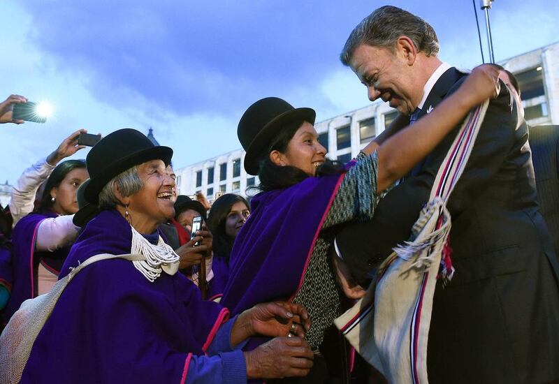 Colombian president Juan Manuel Santos receiving handicrafted presents from Misak natives. AFP Photo

