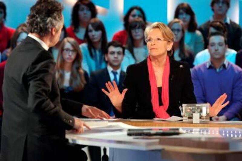 French Foreign Minister Michele Alliot-Marie tals to French journalist Michel Denisot during the TV show "Le Grand Journal" on the French Canal + tv channel, on February 2, 2011. The minister was accused yesterday of taking a flight in the private jet of a Tunisian businessman allegedly close to ousted strongman Zine El Abidine Ben Ali. Alliot-Marie's office confirmed she had accepted a flight during a holiday in late December last year -- after the start of protests against Ben Ali's regime -- but denied the tycoon was a crony of the then-dictator. AFP PHOTO THOMAS SAMSON
 *** Local Caption ***  200310-01-08.jpg